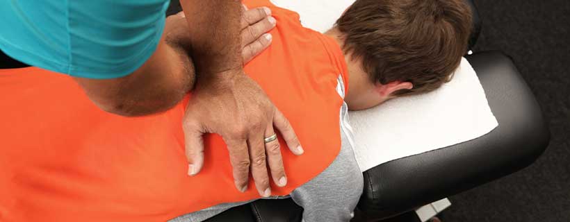 patient receiving drop table chiropractic in Lexington for auto accident injury pain relief
